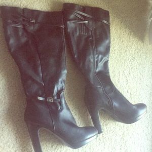 Black leather heel boots with buckle detail